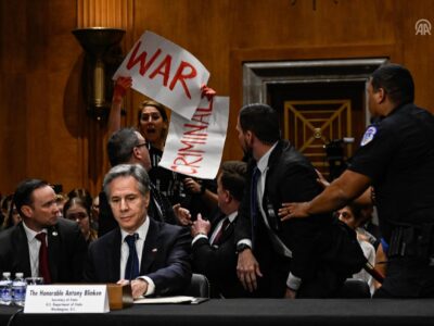 Anti-war activists protest as Secretary of State Antony Blinken testifies before the Senate Foreign Relations Committee.
